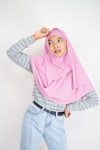 Portrait of a girl standing against white background