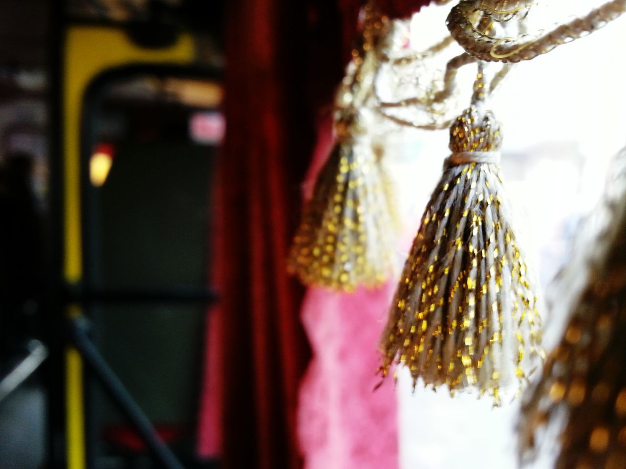 focus on foreground, close-up, selective focus, hanging, flower, decoration, outdoors, freshness, day, religion, growth, no people, nature, tree, fragility, cultures, plant, beauty in nature, red