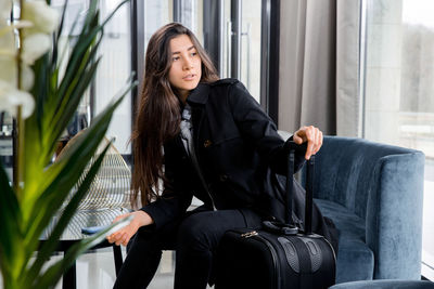 Woman sitting on sofa at restaurant