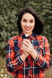 Portrait of beautiful woman while standing outdoors