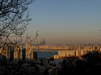 Buildings in city against sky during sunset