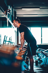 Side view of man exercising in gym