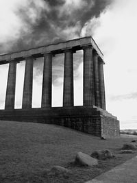 Low angle view of historical building against cloudy sky