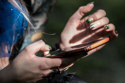 Close-up of man using mobile phone outdoors