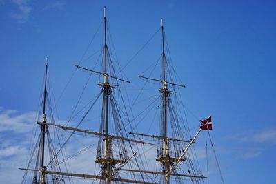 Sailboat moored against blue sky