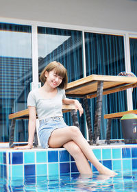 Portrait of a smiling young woman swimming pool