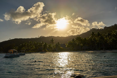 Scenic view of river against sky at sunset