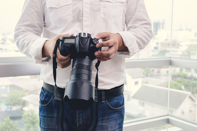 Midsection of man photographing