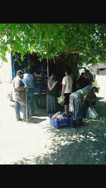 People sitting at market stall