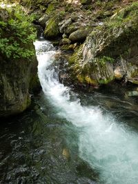 River flowing through rocks in forest