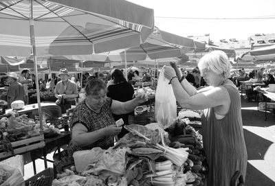 People standing at market stall