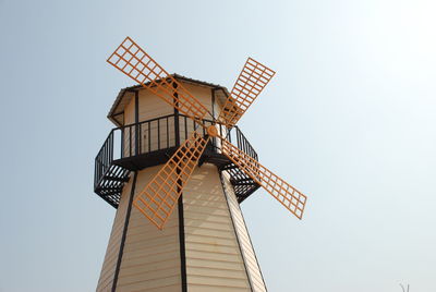 Low angle view of traditional windmill against clear sky