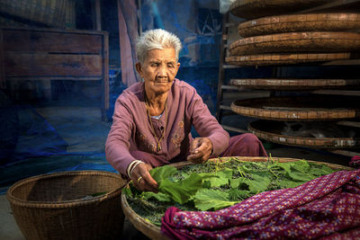 Senior woman with vegetables in wicker basket