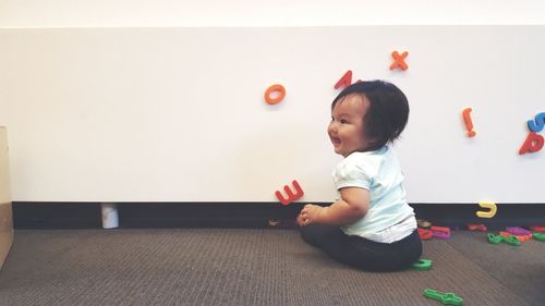 Cute girl playing with toy at home