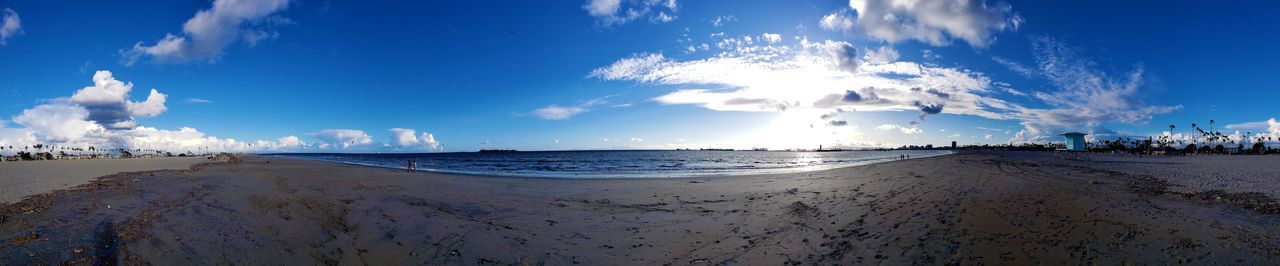 Panoramic view of beach against blue sky