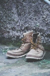 Close-up of shoes on rock