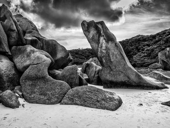 Rocks on beach against sky