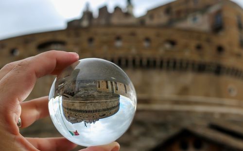 Midsection of person holding crystal ball