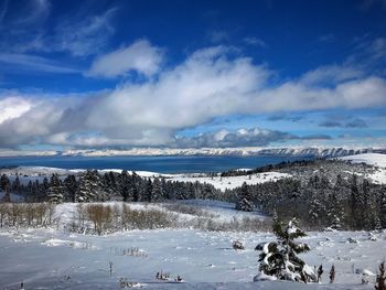 Snow covered landscape against sky