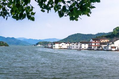 Scenic view of sea and buildings against sky