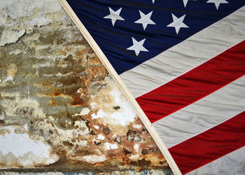 Close-up of flags against blue wall