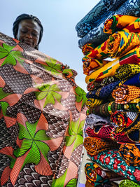Ghana woman looking at various fabrics in accra market located in ghana west africa.