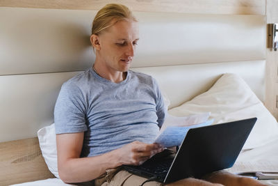 Young man using laptop at home