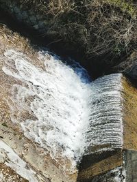 High angle view of water flowing through rocks