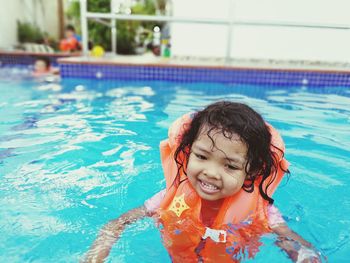 Close-up of girl swimming in pool