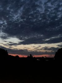 Silhouette landscape against dramatic sky