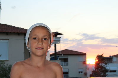 Portrait of shirtless girl standing against sky during sunrise