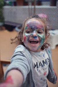 Children playing in an inner courtyard and painting with water paints