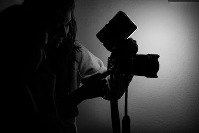Close-up of man photographing camera