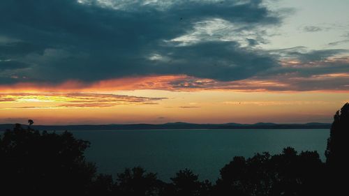 Scenic view of sea against orange sky