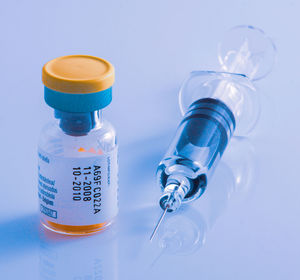 Close-up of glass bottle against blue background