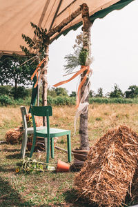 Chairs on field against sky