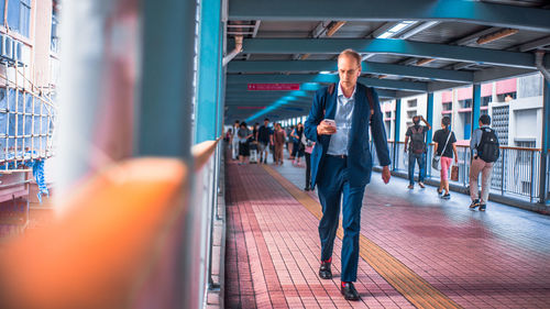 People walking on railway station platform