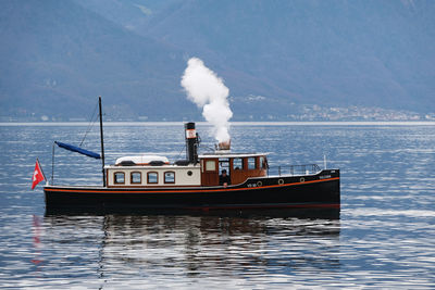 Ship sailing on sea against sky