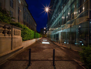 Illuminated city street at night