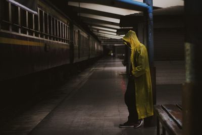 Side view of woman walking on railroad station platform