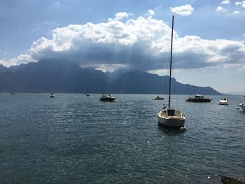 Sailboats in sea against sky