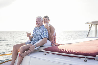 Happy couple having a drink on a boat trip