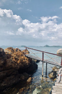 Bridge over sea against sky