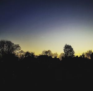 Silhouette trees against sky during sunset