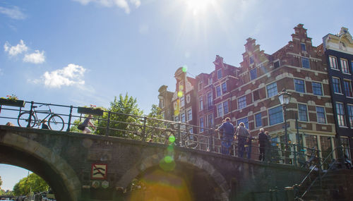 Low angle view of bridge in city against sky