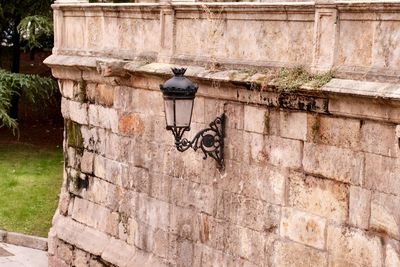 Bicycle parked against brick wall