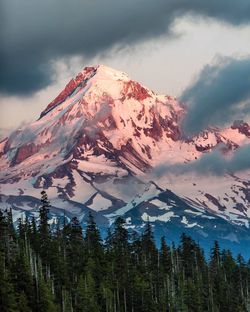 Low angle view of snowcapped mountains against sky