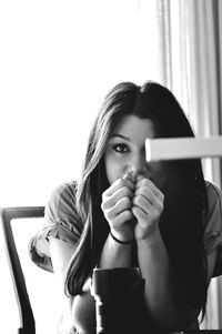 Portrait of young woman drinking coffee