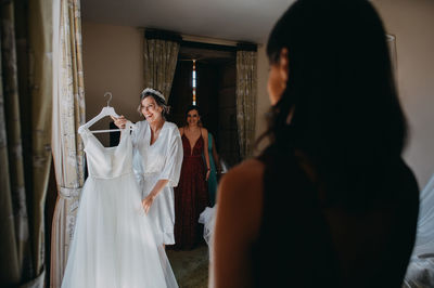 Rear view of women standing in corridor