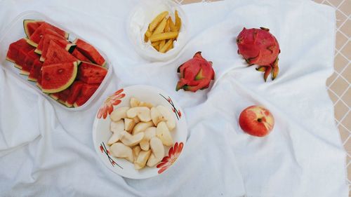 High angle view of chopped fruits in bowl on table